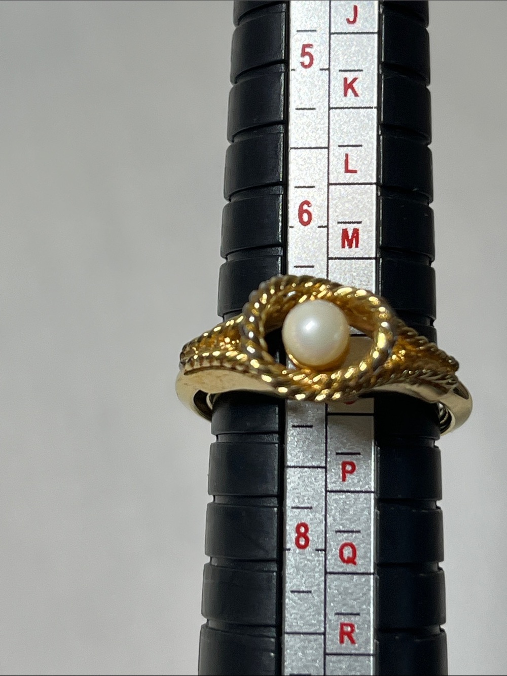 Vintage Avon ring with adjustable sizing
Gold Pearl Twist Knot Ring